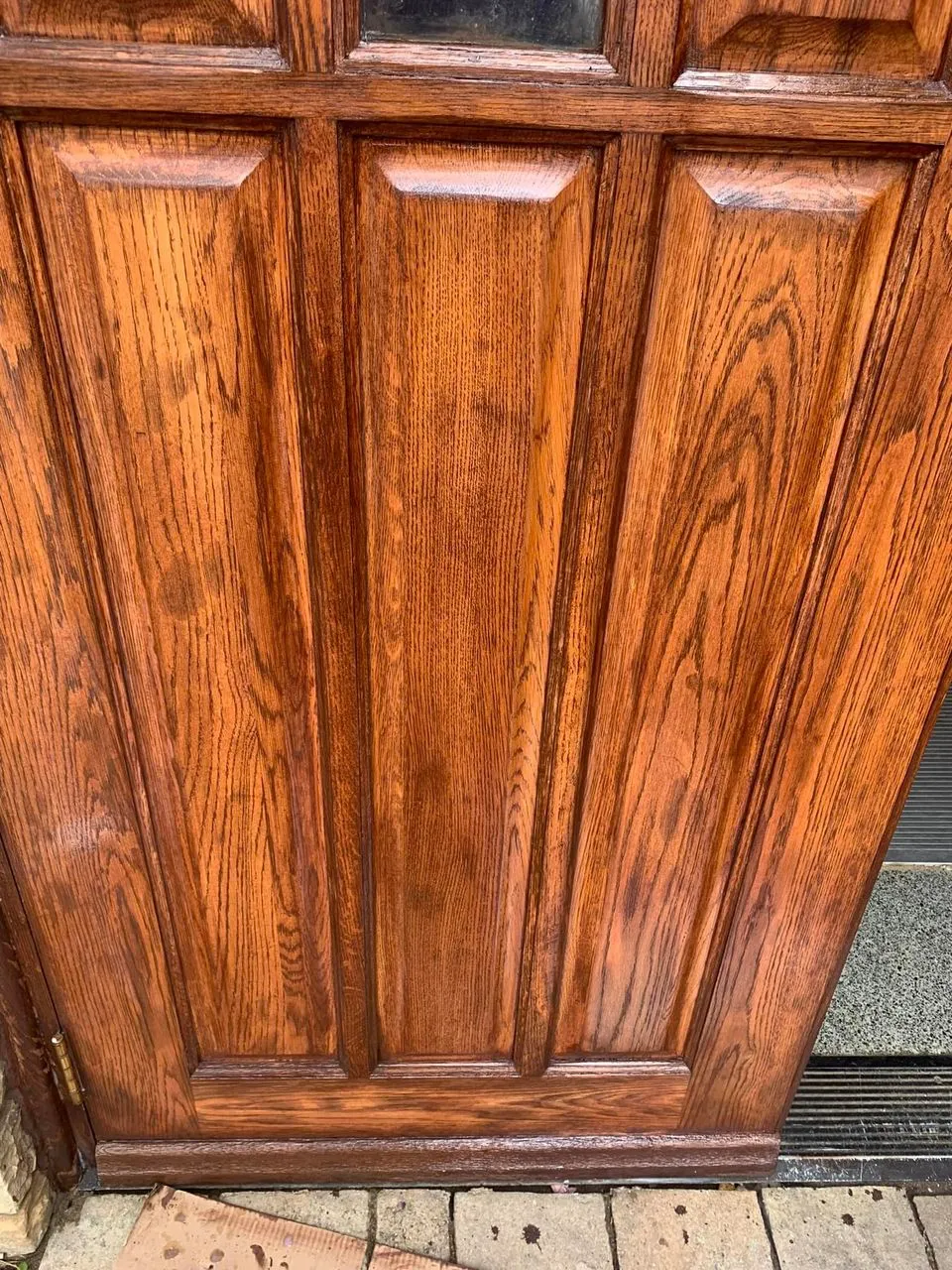 Restored solid oak entry door with refinished wood grain
